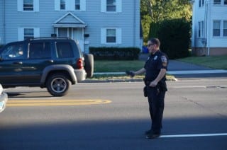 West Hartford Police Officer Mike Coyne waves over a driver on New Britain Avenue who was spotted by another officer down the road. The driver doesn't notice Mike until the last minute, because he was still on the phone. Photo credit: Ronni Newton.