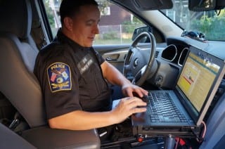 West Hartford Police Officer Mike Coyne processes an E-ticket for a cellphone violation. Photo credit: Ronni Newton.