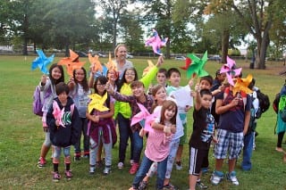 John Foster's 5th grade class shows off the pinwheels they made for the International Day of Peace celebration at Charter Oak International Academy on Sept. 22. Photo credit: Keith Griffin.