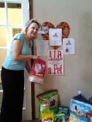 Nutritionist Lorie Reardon picks up a donation for Aid-a-Pet at Joe Cornfield's Wallpaper. Submitted photo.