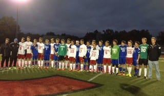 Seniors from the Conard and Hall boys soccer teams pose for a photo with their coaches before the game. Photo credit: Anne Marie Riley.