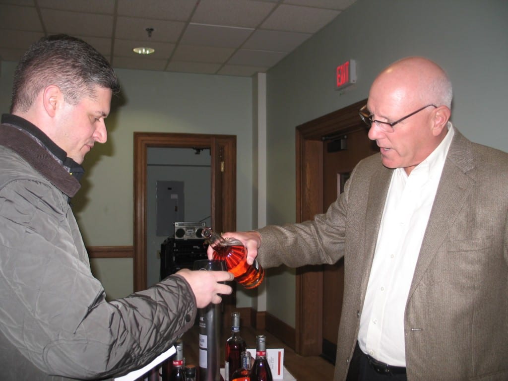 The Winebow Group’s Connecticut Sales Manager Frank Haas pours a sample of Catskill Provisions Honey Rye for West Hartford Mayor Scott Slifka. He expressed thanks that The Town That Cares Fund was chosen as a beneficiary of the fundraiser again this year. Submitted photo