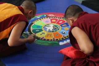 The Monks from The Drepung Gomang Monastic College create a sand mandala painting at Copper Beech Institute (day 3). Photo by Amy Melvin