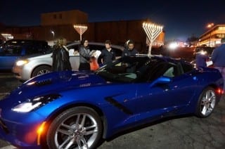 Menorah-topped vehicles get organized in the parking lot behind Crown Supermarket in West Hartford. The Corvette Stingray belongs to Michael Black of Chabad House of Greater Hartford. Photo credit: Ronni Newton