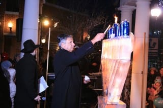 Gary Greenberg lights the menorah at the “Fire on Ice” Chanukah celebration in Blue Back Square on December 21, 2014. Photo by Joy Taylor
