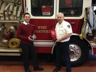 Dr. Corey Shagensky of Progressive Animal Wellness (left) presents West Hartford Fire Department Chief Richard Winn (right) with a pet oxygen mask.  PAW’s pet portrait event in November raised enough money to purchase seven pet oxygen mask kits for the West Hartford Fire Department. Submitted photo