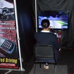 Ryan Sands '15 attempts to text while driving a simulator. Submitted photo