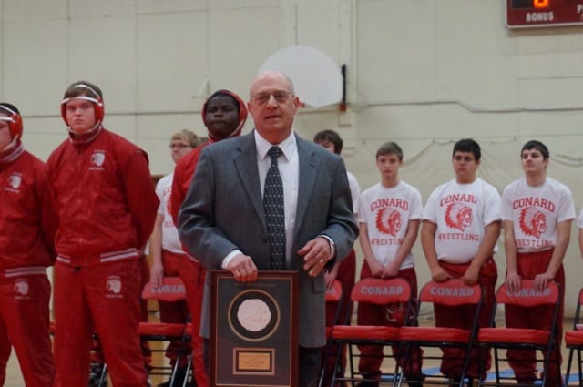 Brad Beaudry, son of former Conard coach George Beaudry, presents his father's Hall of Fame plaque to Conard. Photo credit: Ronni Newton