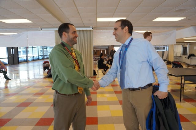 Conard Principal Julio Duarte (left) shakes hands with Hall Principal Dan Zittoun before their match. Photo credit: Ronni Newton