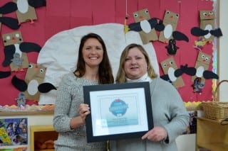 Annie Steckroth of Hulafrog (left) presents Knight Hall School Director Martha Wylie with a certificate naming Knight Hall the 'Most Loved Preschool' in the Hartford area. Submitted photo