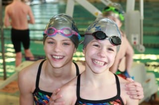 West Hartford Waves teammates Cate Mancini (left) and Julia Seguro are headed to the Central Connecticut Winter Swim League’s “A” Championship meet on Feb. 15. The pair was part of a winning medley relay team on Sunday against Farmington. Submitted photo