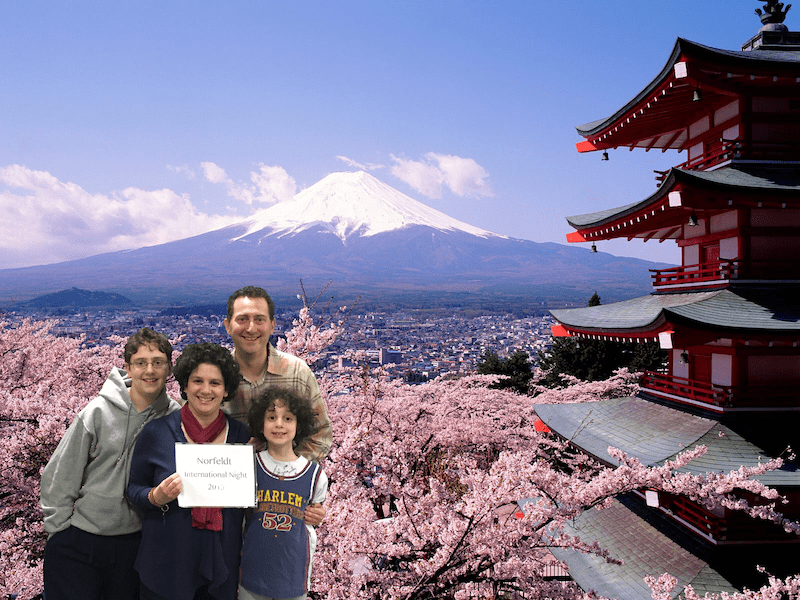 Deena Shefsky (front) and her family take a virtual trip to Japan via green screen technology at Norfeldt's International Night. Submitted photo