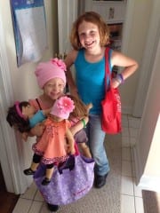 Kiley Sullivan, her 9-year-old sister Allie, and lots of American Girl dolls. Photo courtesy of Emily Sullivan