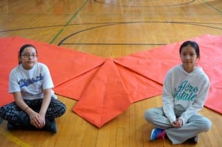 Annie Lopez-Lopez (left) and Amy Ni, Webster Hill 5th graders, folded what they hope is the new Guinness World Record largest origami butterfly. Photo credit: Ronni Newton