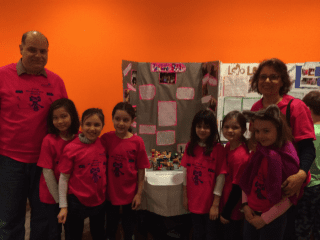 Team Brownie Bots and coaches in front of their model of a working carousel at the Junior First LEGO League Expo.  Pictured from left to right: Coach Dr. Lubomir Ribarov, Meghan Jo, Grace Piccioli, Kathryn Ribarov, Kiera Klein, Catherine Zehr, Katherine Kamin and Coach Kim Piccioli. Submitted photo