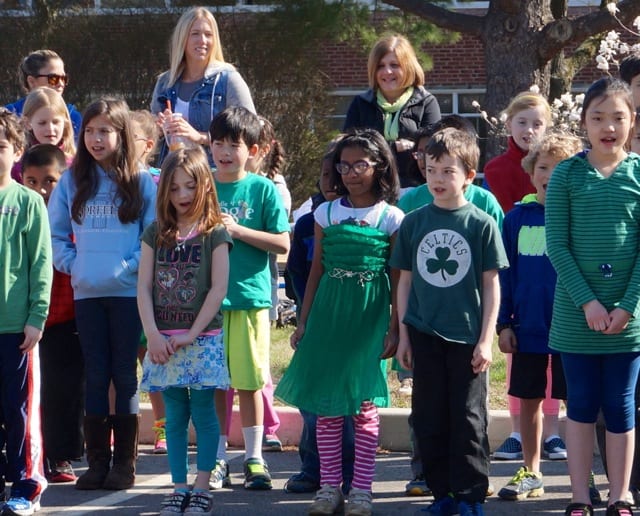 Norfeldt second graders sing about recycling, reusing, and reducing at an Earth Day ceremony. Photo credit: Ronni Newton
