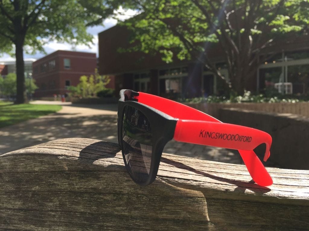 Their surprise swag – KO sunglasses – came in handy for Kingswood Oxford’s 91 seniors when they assembled on the steps of Alumni Hall for their traditional class photo. Photo by Michelle Murphy