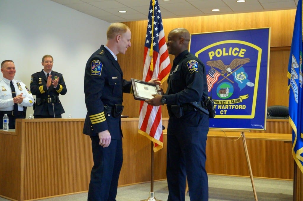 West Hartford Police Chief Tracey Gove presents a Merit Award to Off. Timothy Cammerl for his work on a drug/weapons arrest. Photo credit: Ronni Newton