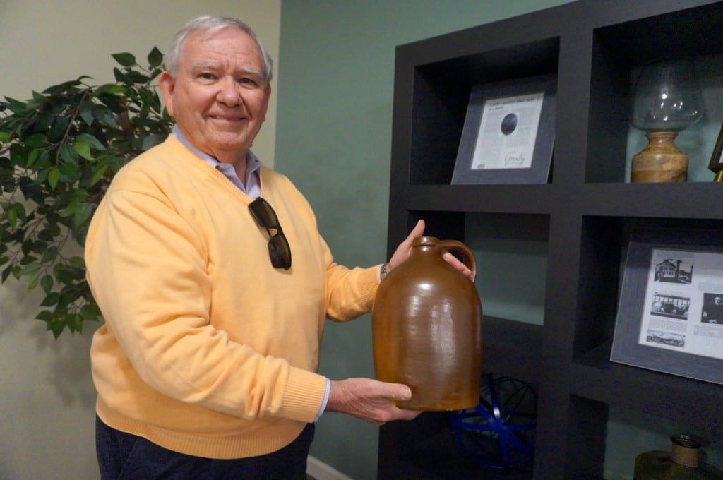 WHHA CEO shows off the original piece of Goodwin pottery on display in the social room. Photo credit: Ronni Newton. 