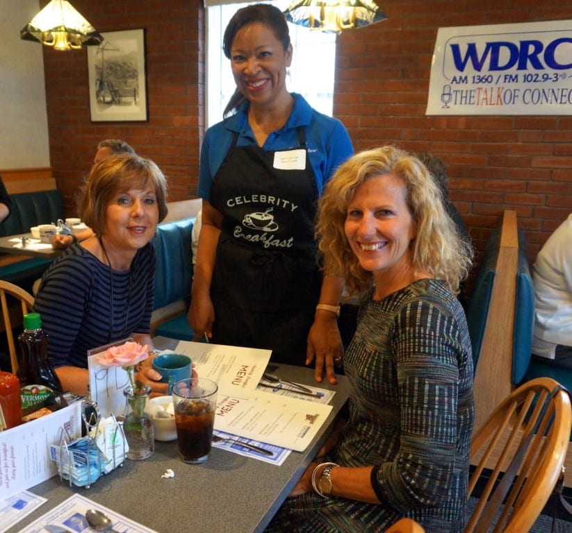 BK&Co. owners (seated, from left) Karen Herbert and Barbara Karsky are attended to by Town Council member Judy Casperson. Celebrity Breakfast. June 9, 2015. Photo credit: Ronni Newton