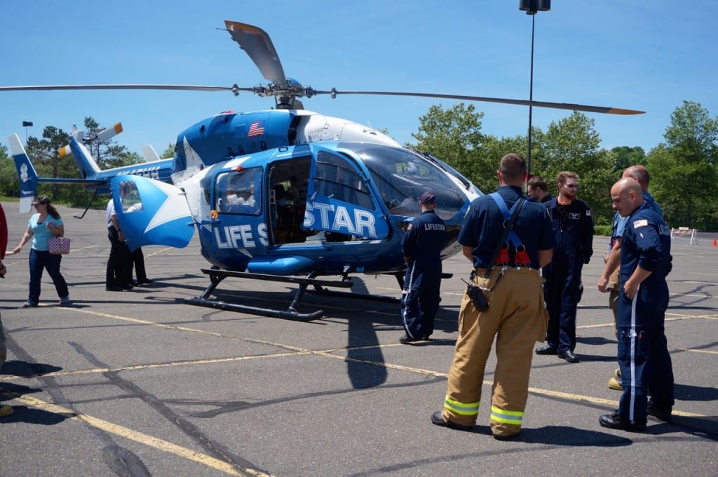 Members of the West Hartford and Farmington fire departments are present at the celebratory 30th anniversary landing of the Life Star helicopter at Westfarms. Photo credit: Ronni Newton
