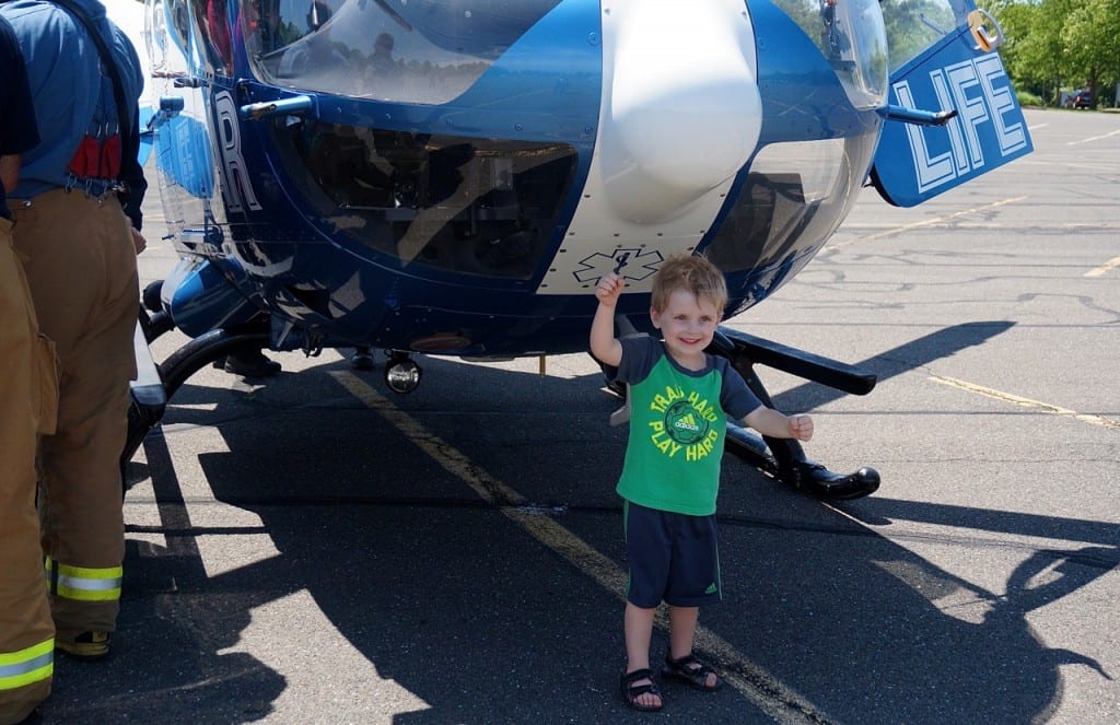 Four-year-old Thomas Muro of West Hartford is excited to be able to touch the Life Star helicopter. Photo credit: Ronni Newton