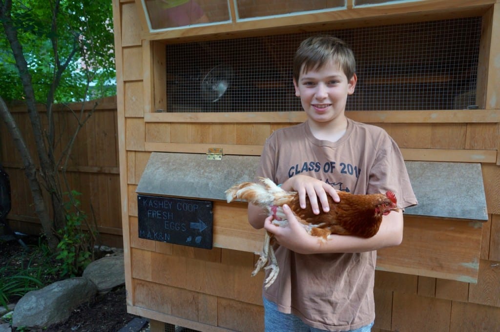 Kai Kashey holds one of his pet chickens. Photo credit: Ronni Newton