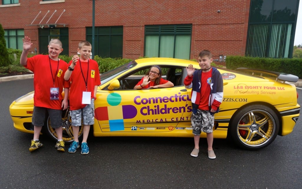 From left: Connecticut Children's Medical Center patients Nate Wilkos, Chase Olin, Aliana Fichera (in car) and David Stone. Concorso Ferrari & Friends, June 28, 2015. Photo credit: Ronni Newton