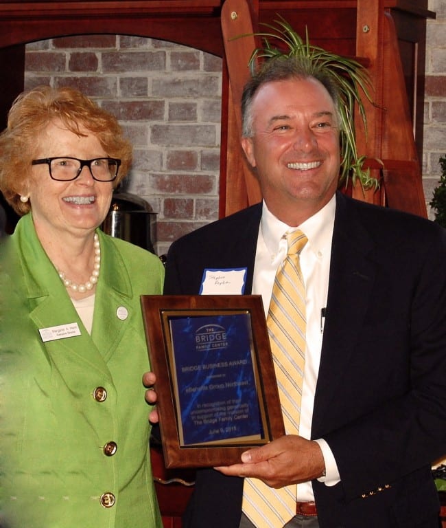 Stephen J. Repka II (right), co-founder and principal of eBenefits Group, accepts the Bridge Business Award from Executive Director Margaret Hann. Submitted photo