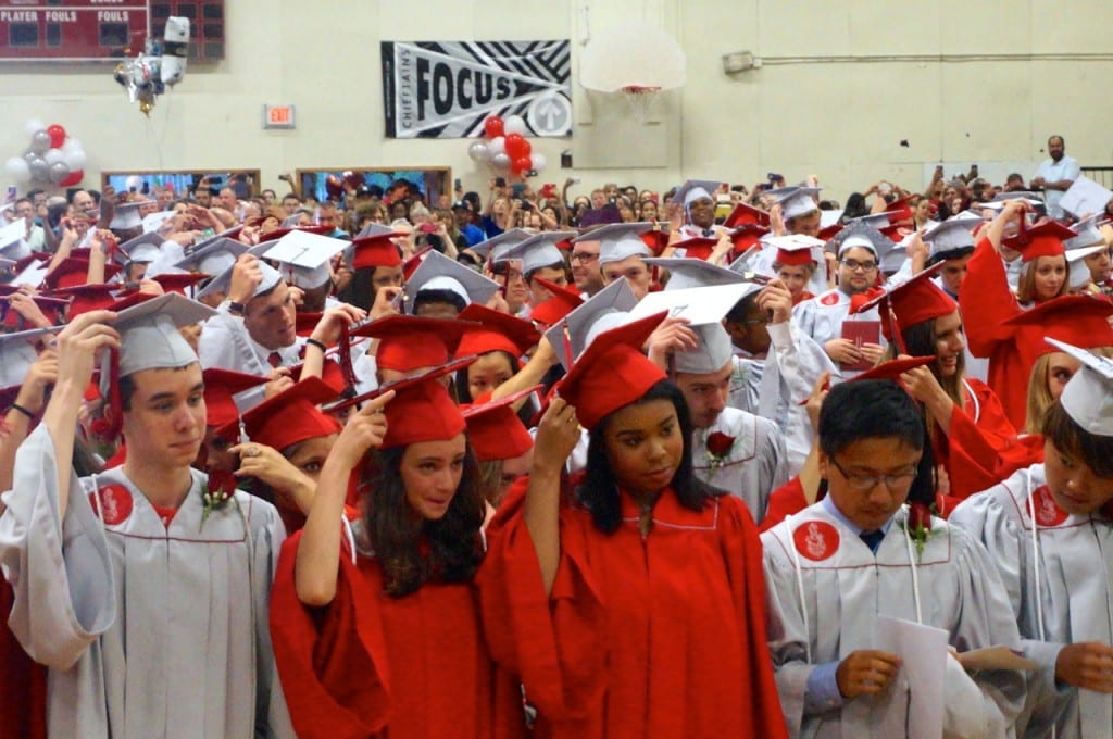 Tassels are switched from right to left as the graduation is official. Conard High School graduation. June 15, 2015. Photo credit: Ronni Newton