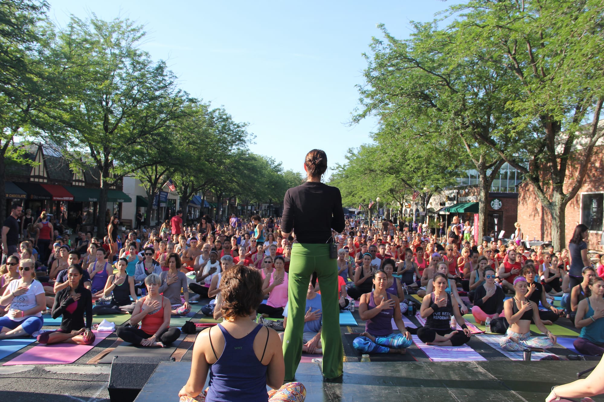 Om Street 2015, presented by West Hartford Yoga on LaSalle Road, July 25, 2015. Barbara Ruzansky surrounded by fellow instructors and participants. Photo by Amy Melvin