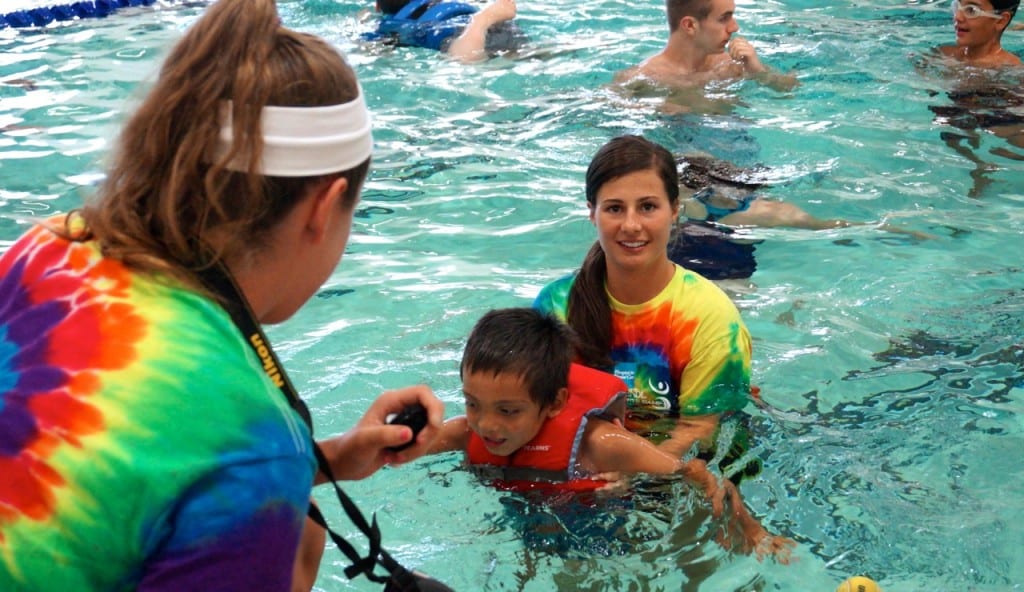 A volunteer at the Ivan Lendl Adaptive Sports Camp supports one of the youngest campers in the accessible pool at the University of Saint Joseph in West Hartford. Photo credit: Ronni Newton