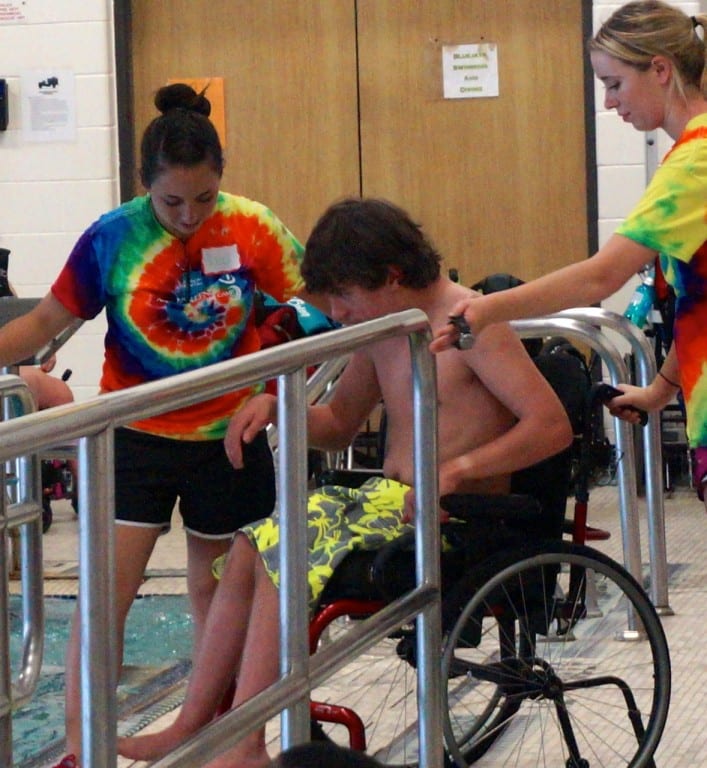 Volunteers at the Ivan Lendl Adaptive Sports Camp guides a camper into the accessible pool at the University of Saint Joseph in West Hartford. Photo credit: Ronni Newton