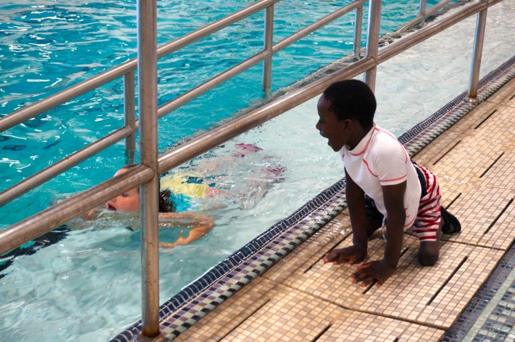 A young camper waits his turn to enter the accessible pool at the Ivan Lendl Adaptive Sports Camp at the University of Saint Joseph in West Hartford. Photo credit: Ronni Newton