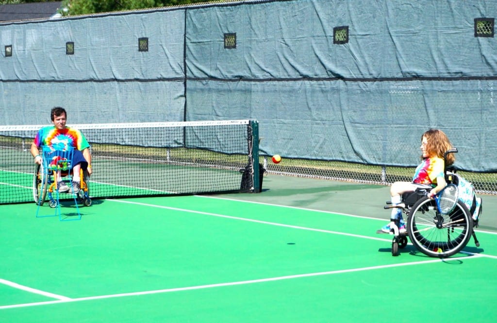 A counselor (left) and camper work on tennis skills at the Ivan Lendl Adaptive Sports Camp at the University of Saint Joseph in West Hartford. Photo credit: Ronni Newton