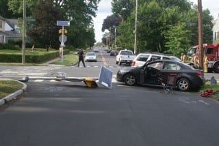 Two vehicles, a mailbox, and a stop sign with solar-powered warning lights were damaged due to a distracted driving accident. Photo courtesy of West Hartford Police
