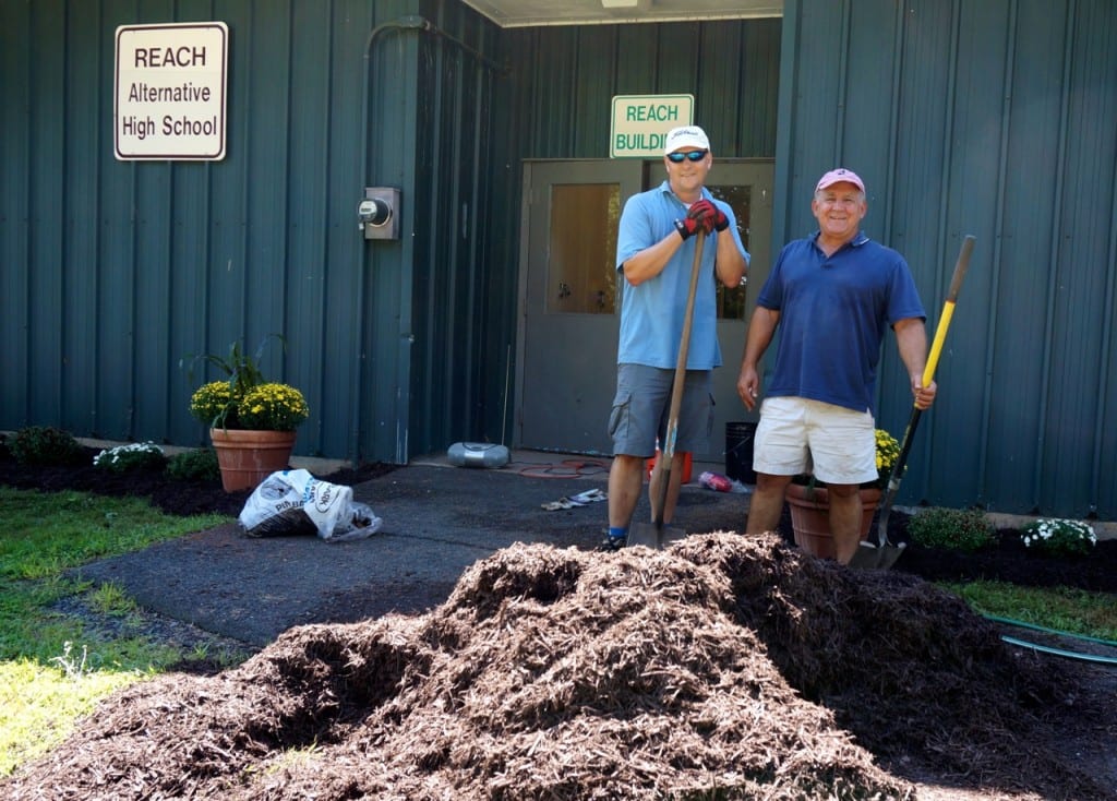 English teacher Jordan Rueckert (left) and administrator Matt Pace spent Saturday landscaping the area around the REACH building to welcome students who will be arriving on Wednesday. Photo credit: Ronni Newton 