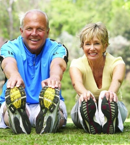 Senior Couple Exercising In Park