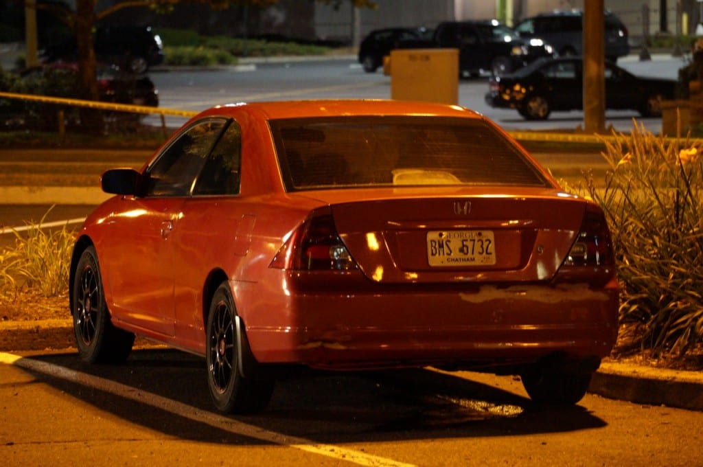 Police discovered a decomposed body inside this red Honda Civic parked at Corbin's Corner. Photo credit: Ronni Newton