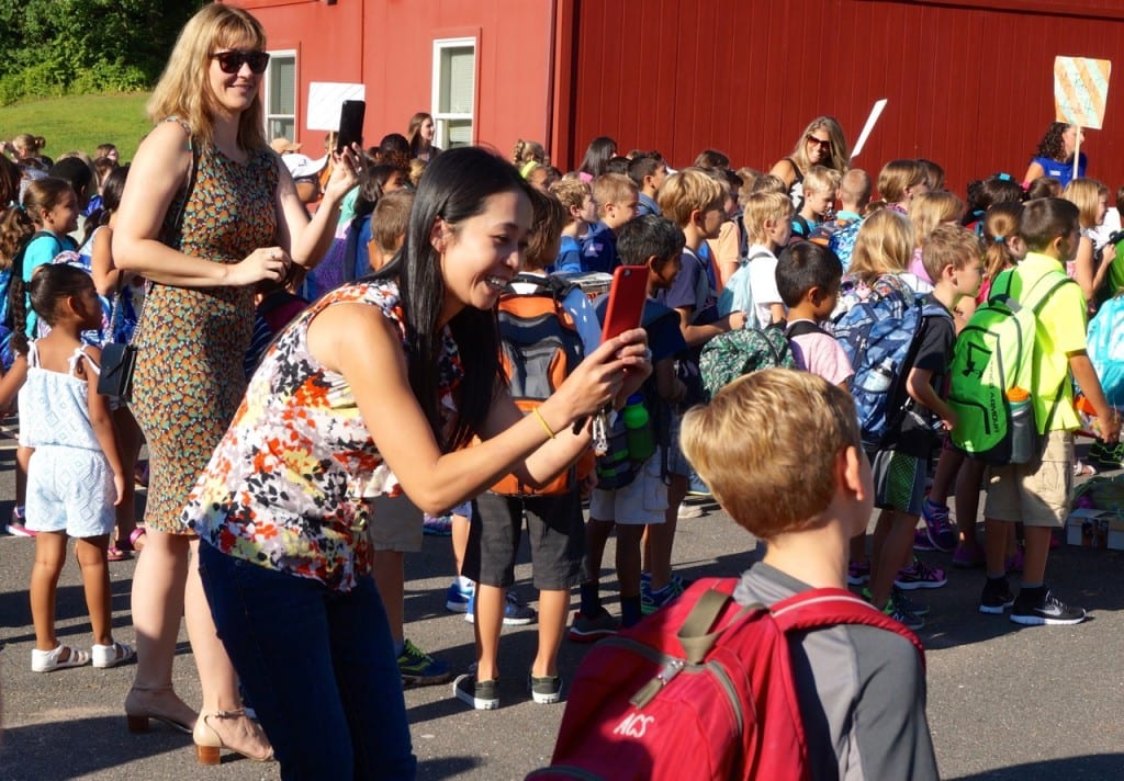Braeburn parents snap photos of their children as they prepare for the first day of school 2015. Photo credit: Ronni Newton