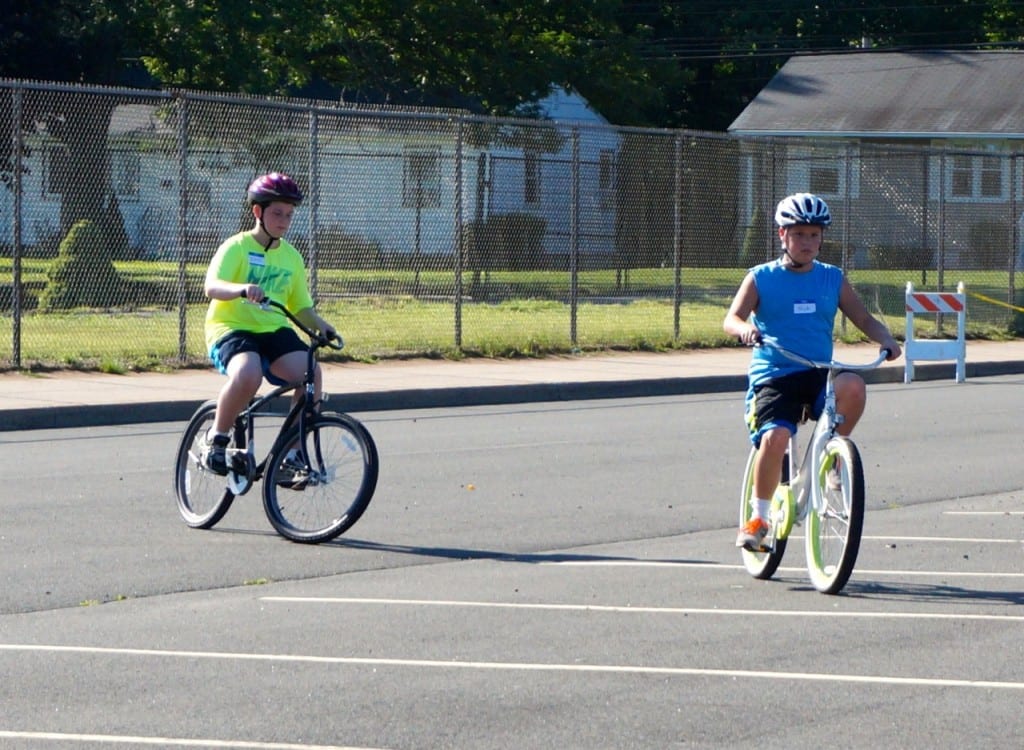 Campers Nate LaBelle (left) and Nick Smith ride independently in the parking lot at Conard High School. Photo credit: Ronni Newton