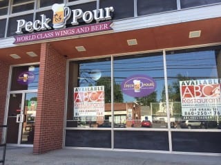 Peck & Pour has closed, and the building owner is advertising for a new tenant. Photo credit: Ronni Newton