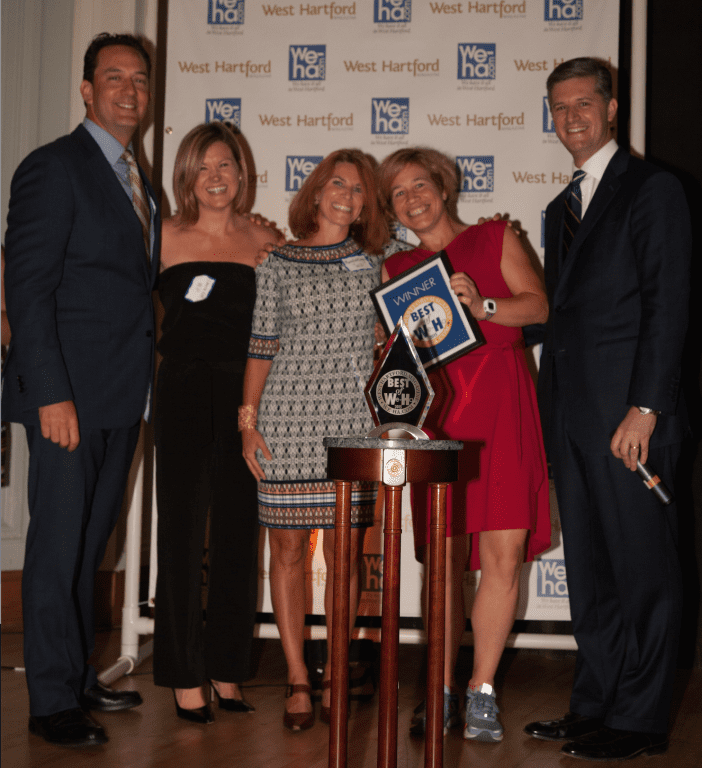 Best Exercise/Fitness: Fleet Feet Sports owner Stephanie Blozy (in red dress and sneakers) invited runner's up WIP Co-Owners Laura Keever and Mary Kate Doyle to stage with NBC Connecticut's Brad Drazen and Mayor Scott Slifka at the Best of West Hartford Awards Show, September 10 2015. Photo by Mick Melvin