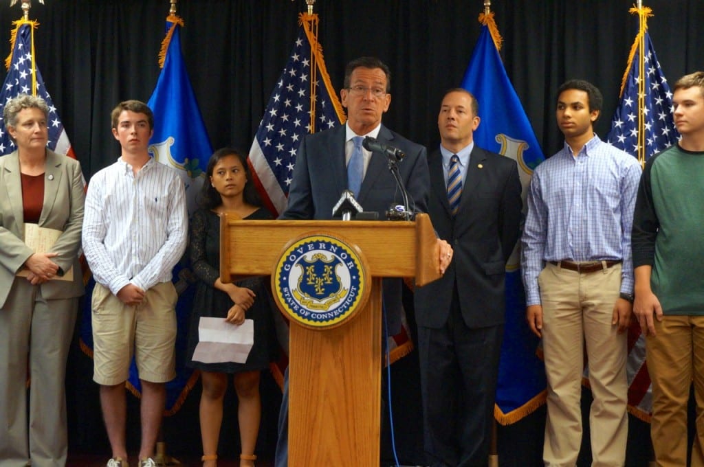 Gov. Dannel P. Malloy speaks at the Conard High School library Tuesday. In the background are (from left) State Sen. Beth Bye, Brian Wilson, State Rep. Andy Fleischmann, Anis Ehsani, and Jack Moore.