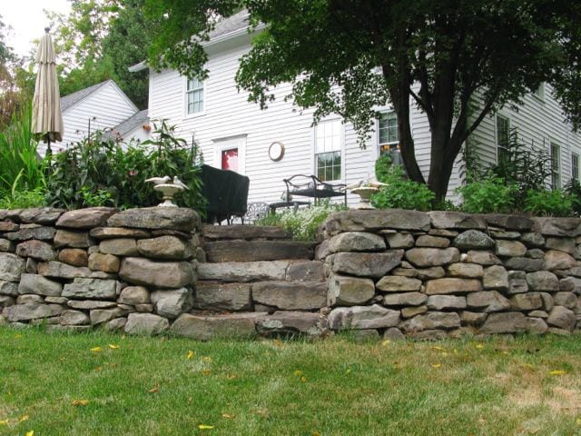 Stone steps in the back corner leading up to their expansive patio. Photo credit: Deb Cohen