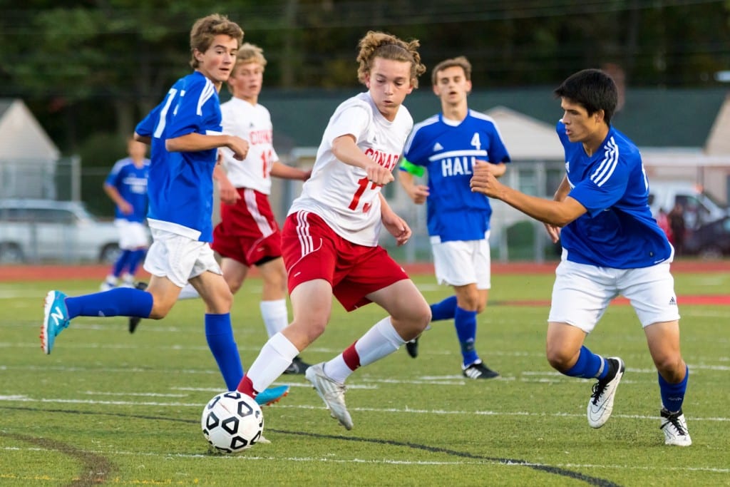 Conard's Jordan Scrimgeour (center) pushes the ball out of the way of Hall's AJ Speranze (right). In background are Hall's Caleb RItter (left), Conard's Lucas Busch (center) and Hall's Connor Sandstrom. Photo courtesy of David Newman. PhotobyNewman.com