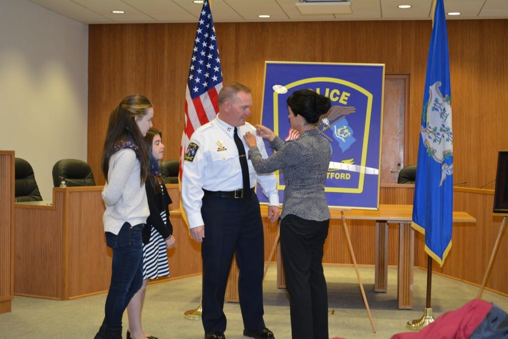 Newly-promoted Capt. Kevin McCarthy is pinned by his wife, Lisa, while daughters Brianna and Allison look on. Photo courtesy of West Hartford Police Department