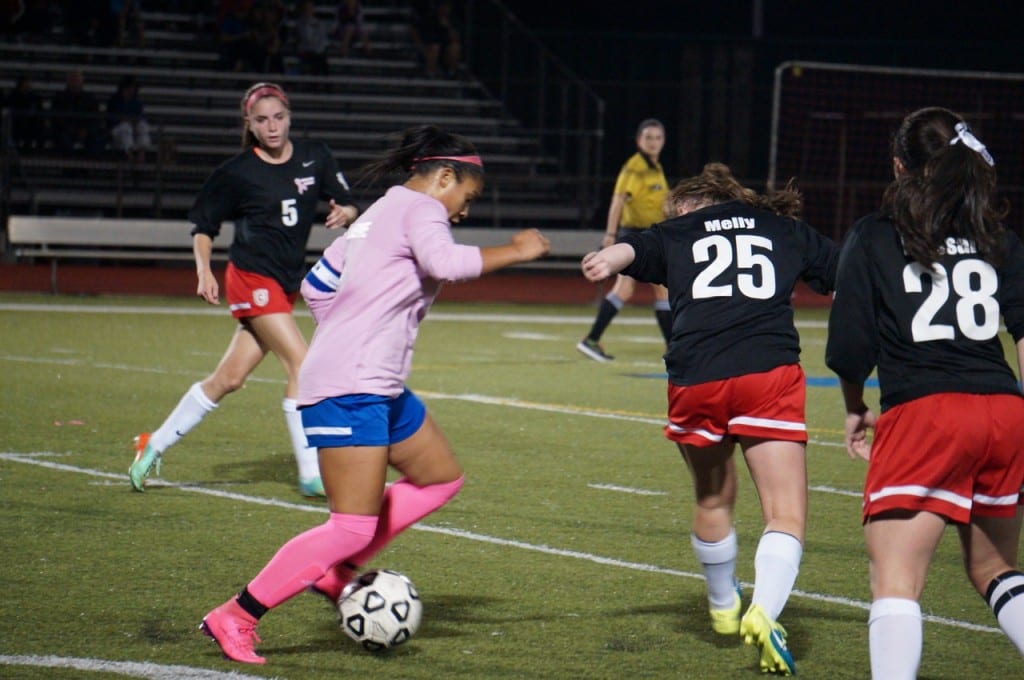 Hall's Kyanna Alleyne works to get past Conard's Margaret Melly (#25) and Kathleen Massaro (#28). In background is Faith Haverty. Hall vs. Conard girls soccer. Oct. 12, 2015. Photo credit: Ronni Newton