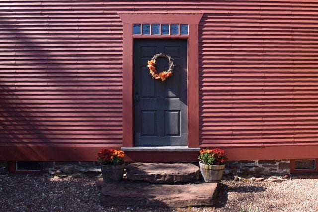 The simple but charming front door of the Noah Webster House is dressed for fall. Photo credit: Deb Cohen