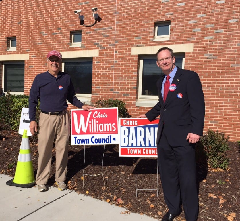 Town Council candidate and incumbent Chris Barnes stands outside Conard High School with Jack Monahan, a supporter of candidate Chris Williams. Photo credit: Ronni Newton